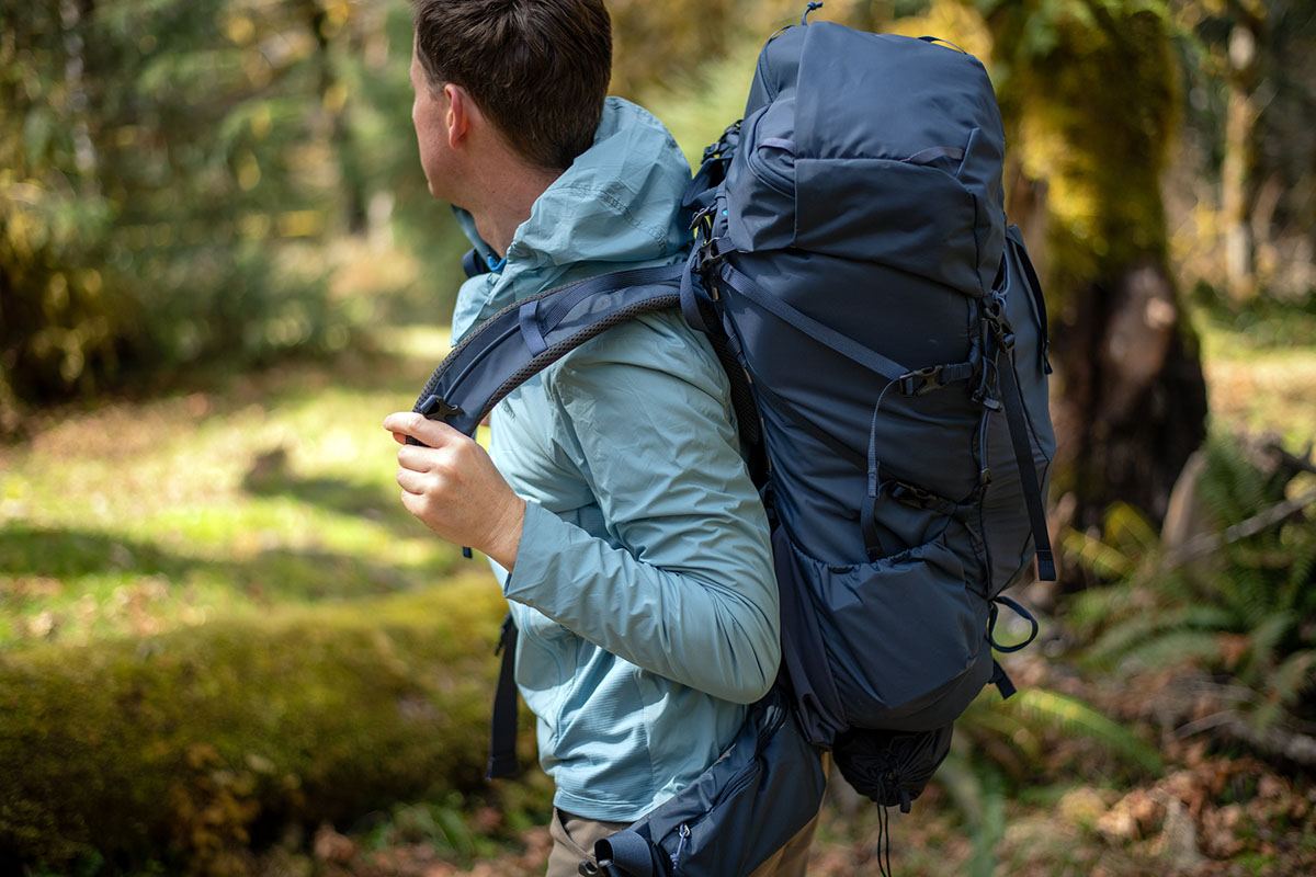 REI Co-op Traverse 60 backpack (putting pack on)